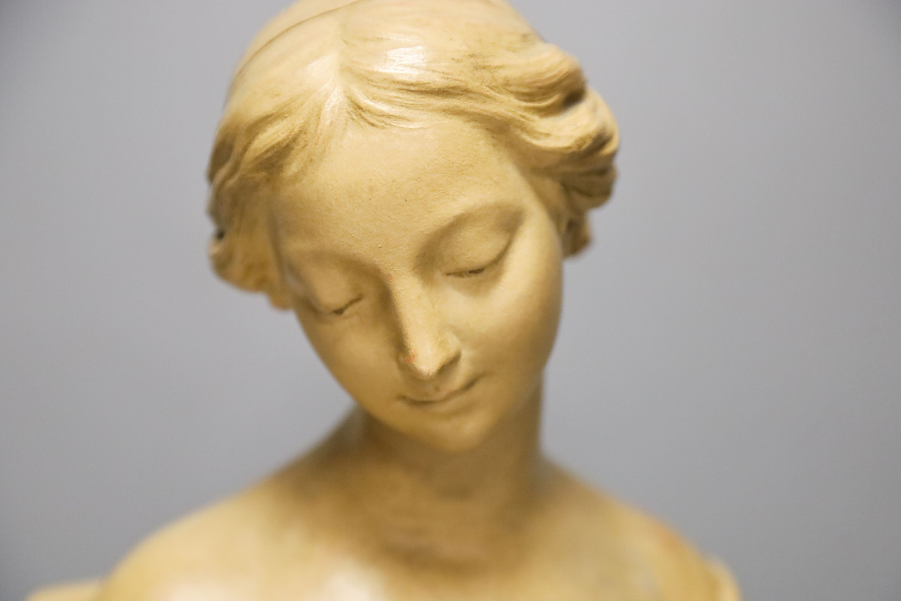 A cream painted terracotta bust of a lady 33cm